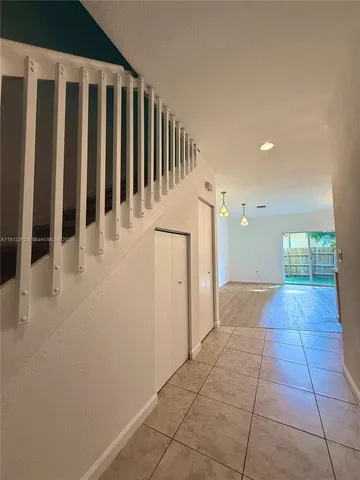 a view of hallway with a window and a kitchen view