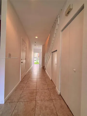 an empty room with a ceiling fan and window