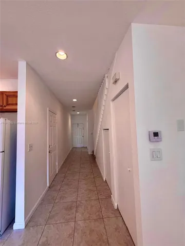 a view of a hallway with stairs