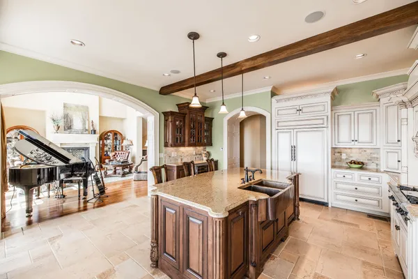 a kitchen with stainless steel appliances granite countertop a stove and a refrigerator