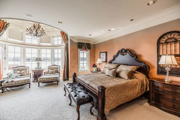 a bedroom with furniture and a large window
