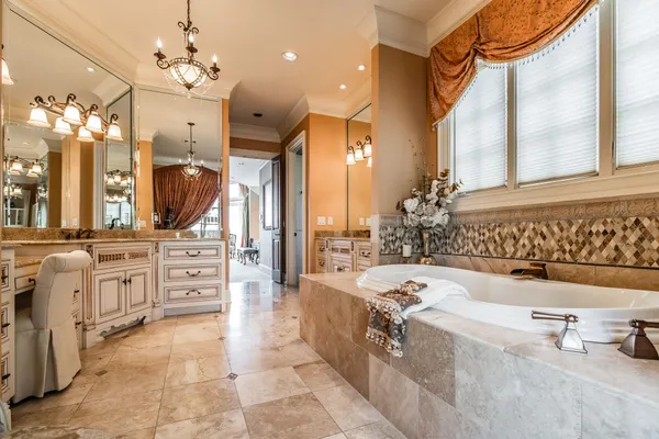 view of a bathroom with a tub sink shower and mirror