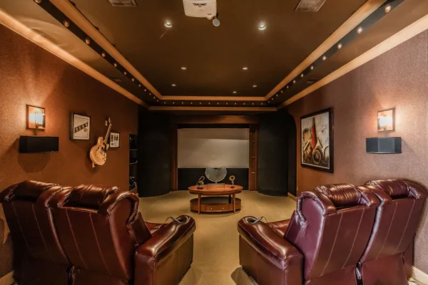 a media room with lots of chairs and a projector screen