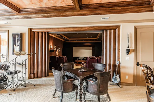 a view of a dining room with furniture and chandelier