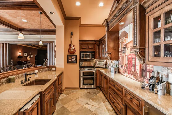 a view of a kitchen with a sink and a refrigerator