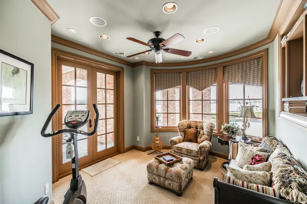 a bedroom with furniture and a large window