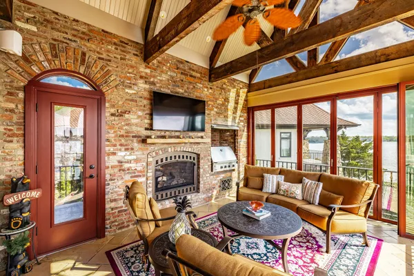 a living room with furniture a fireplace and a flat screen tv