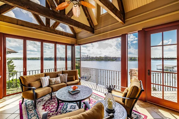 a living room with furniture and a floor to ceiling window