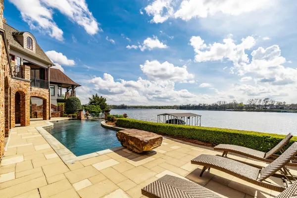a view of a terrace with lawn chairs