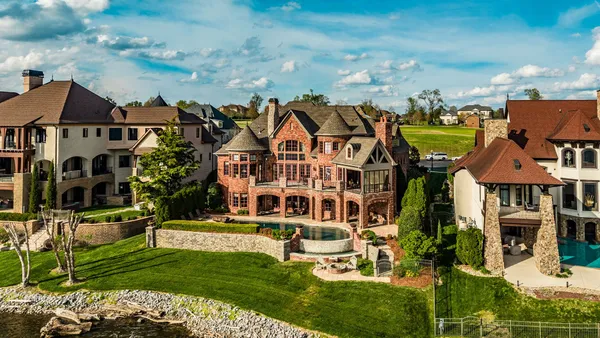 an aerial view of a residential houses with outdoor space lake view