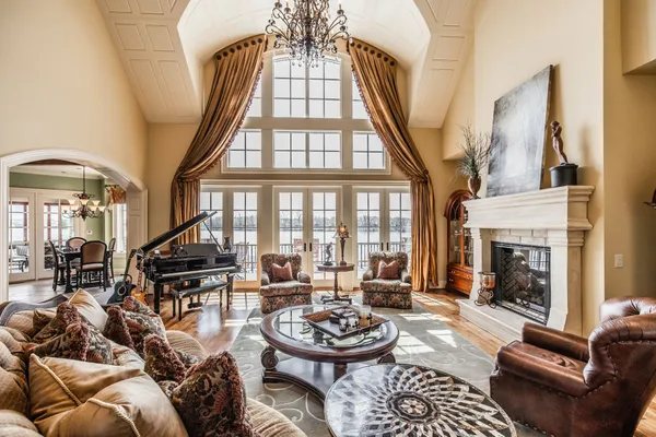 a living room with furniture a fireplace and a large window