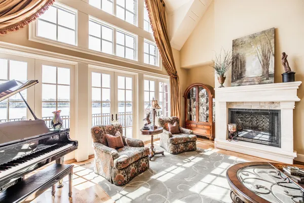 a living room with furniture a fireplace and a floor to ceiling window