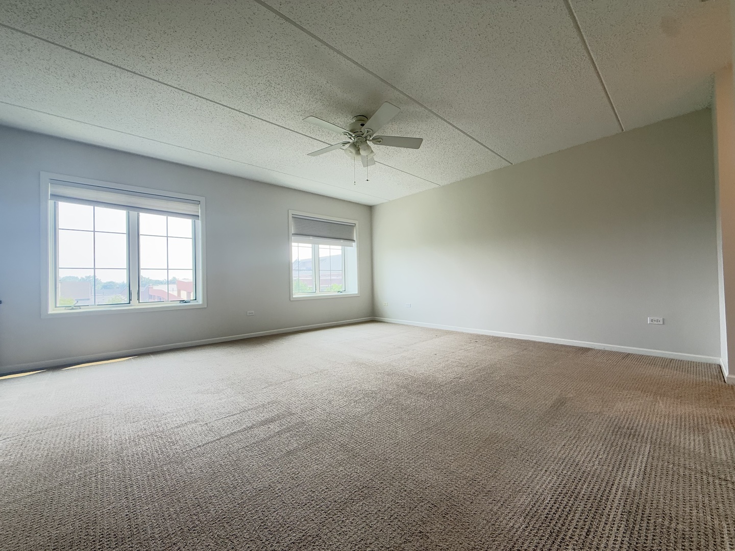 20 South Main Street, Unit 506 Mount Prospect, IL 60056 - Photo 12 of 22 an empty room with a window and a ceiling fan