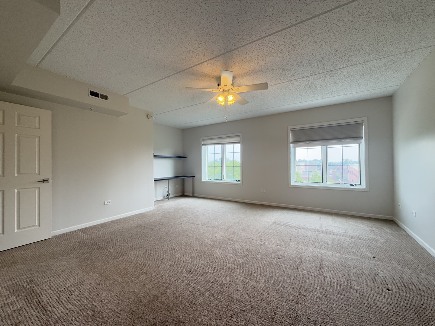 20 South Main Street, Unit 506 Mount Prospect, IL 60056 - Photo 13 of 22 a view of empty room with a ceiling fan and window