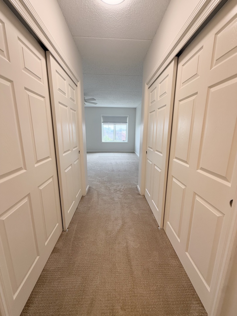 20 South Main Street, Unit 506 Mount Prospect, IL 60056 - Photo 14 of 22 a view of a hallway to rooms