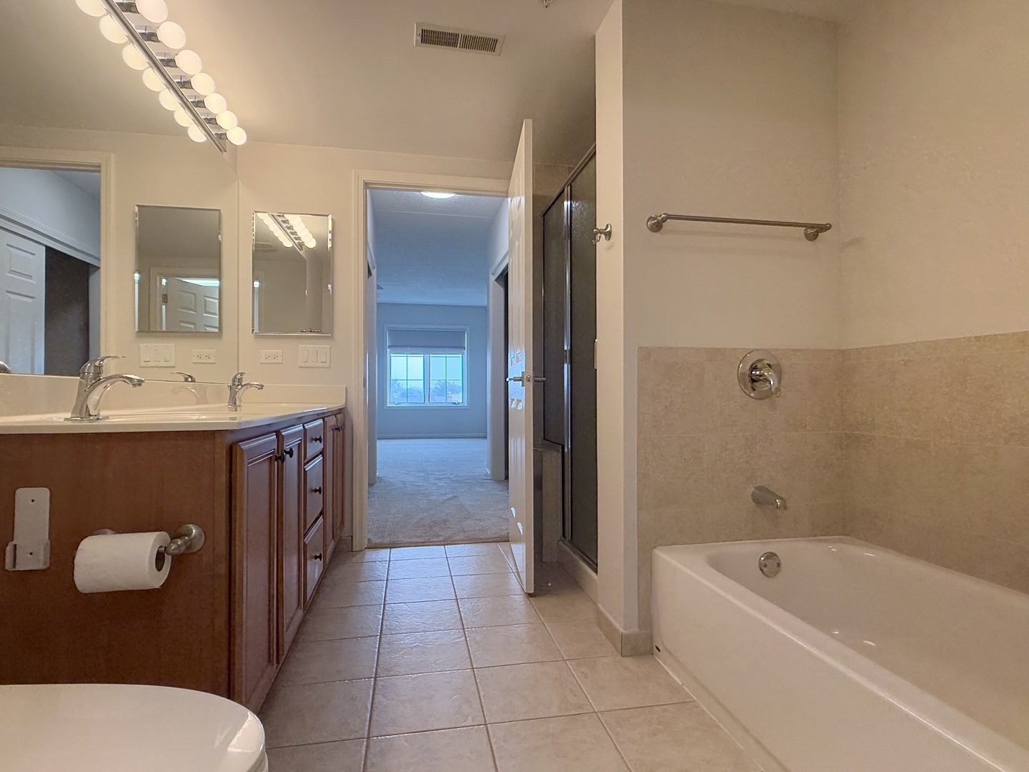 20 South Main Street, Unit 506 Mount Prospect, IL 60056 - Photo 18 of 22 a bathroom with a sink a toilet a mirror and bathtub