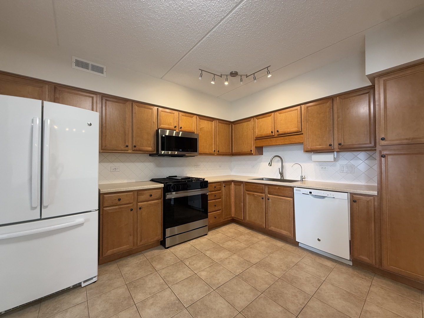 20 South Main Street, Unit 506 Mount Prospect, IL 60056 - Photo 7 of 22 a kitchen with stainless steel appliances granite countertop a refrigerator stove top oven and sink