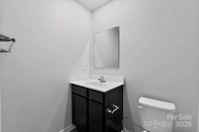 a bathroom with a sink toilet a mirror and shower