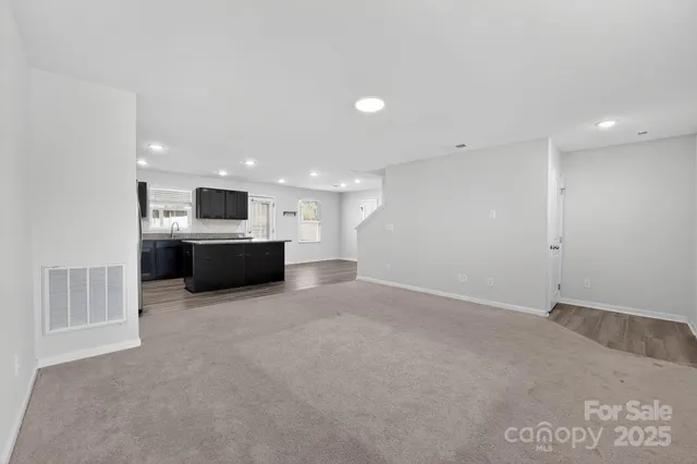 a kitchen with granite countertop sink stainless steel appliances and cabinets
