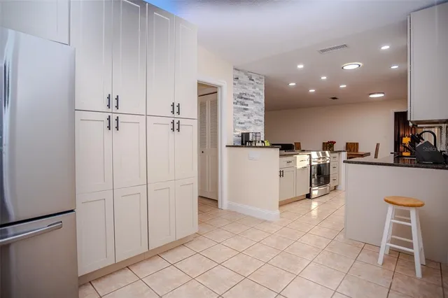 a kitchen with white cabinets and white appliances