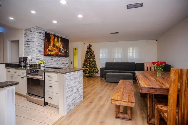 a kitchen that has a lot of cabinets in it and wooden floor