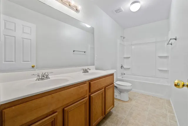 an empty room with fan and windows