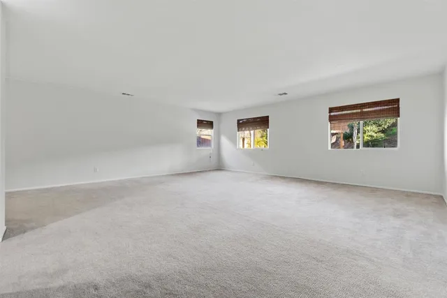 a spacious bathroom with a mirror sink and shower
