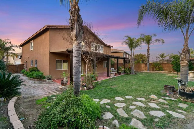 a view of a house with a yard porch and sitting area
