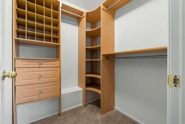 a view of walk in closet with empty racks