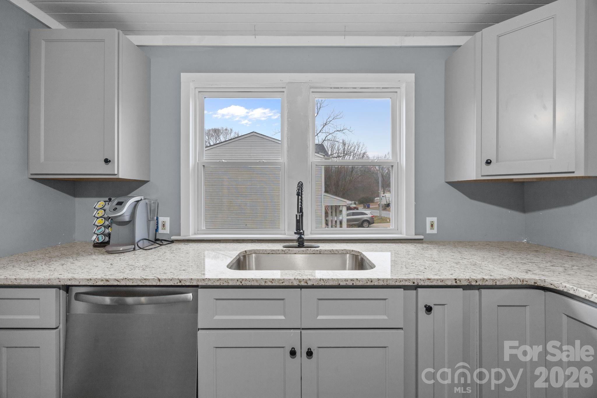 713 2nd St Place Southwest Conover, NC 28613 - Photo 19 of 31 a sink with granite countertop a sink and cabinets