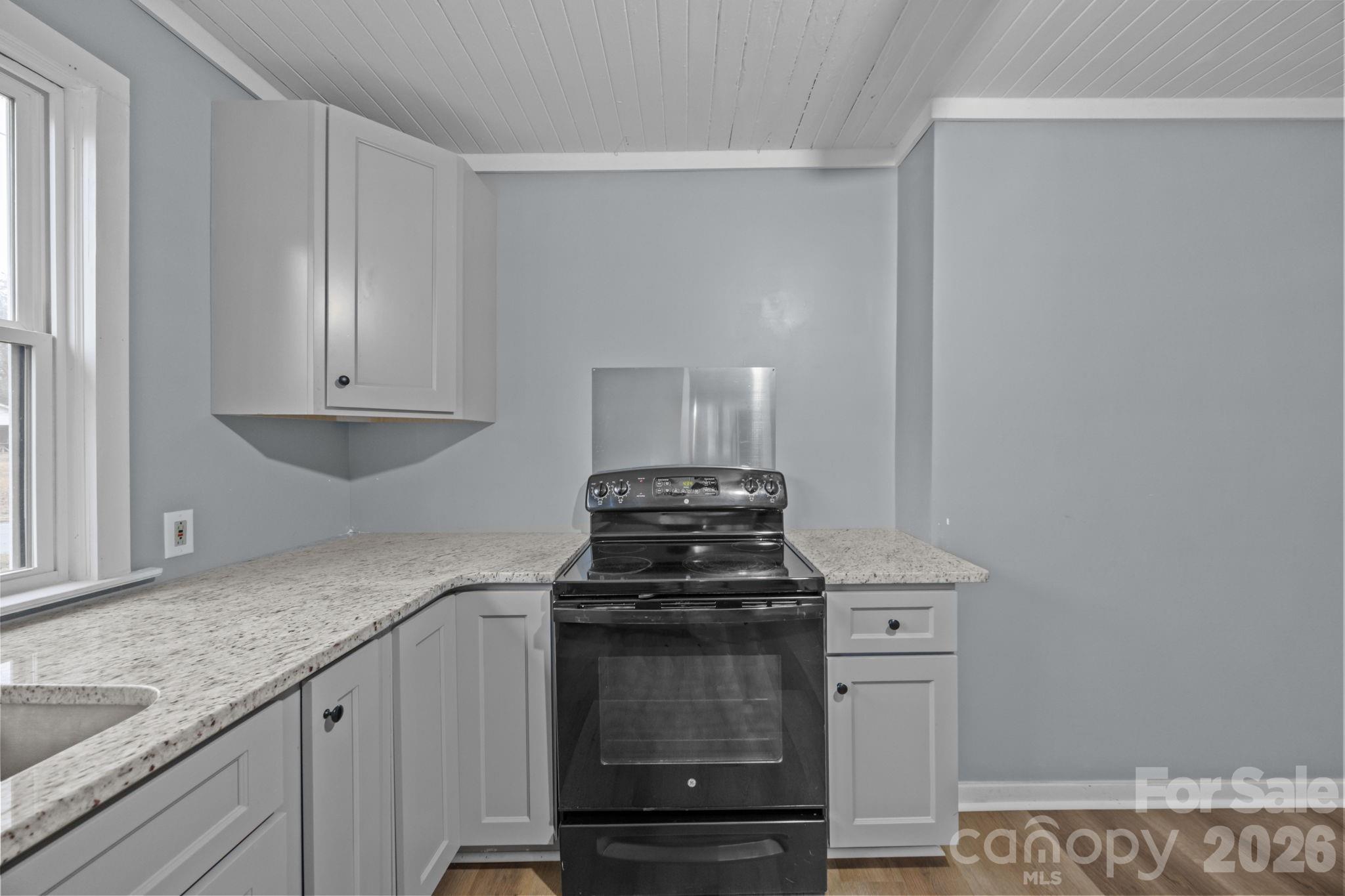 713 2nd St Place Southwest Conover, NC 28613 - Photo 20 of 31 a kitchen with granite countertop a stove and a sink