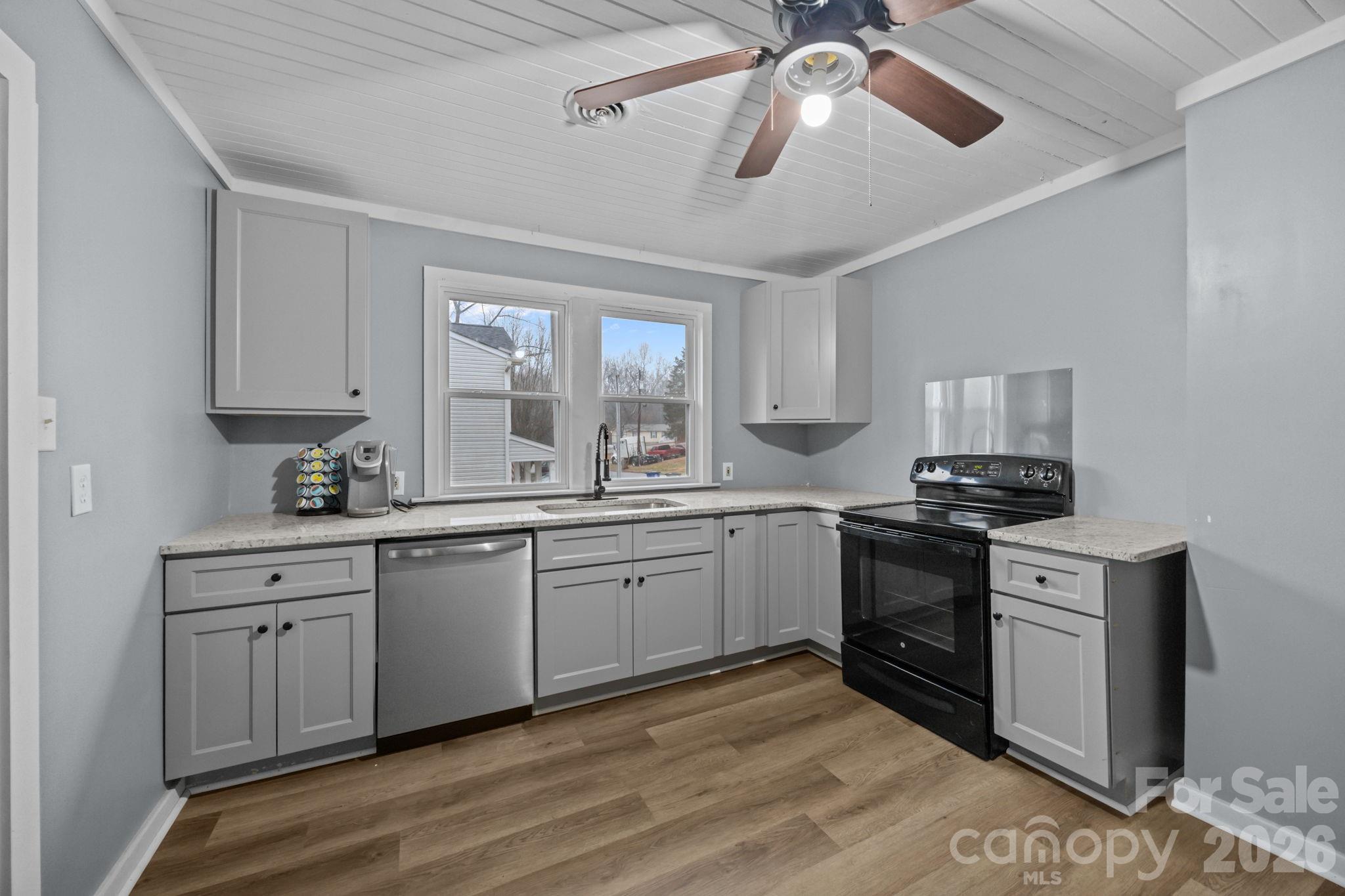 713 2nd St Place Southwest Conover, NC 28613 - Photo 22 of 31 a kitchen with granite countertop appliances cabinets and a sink