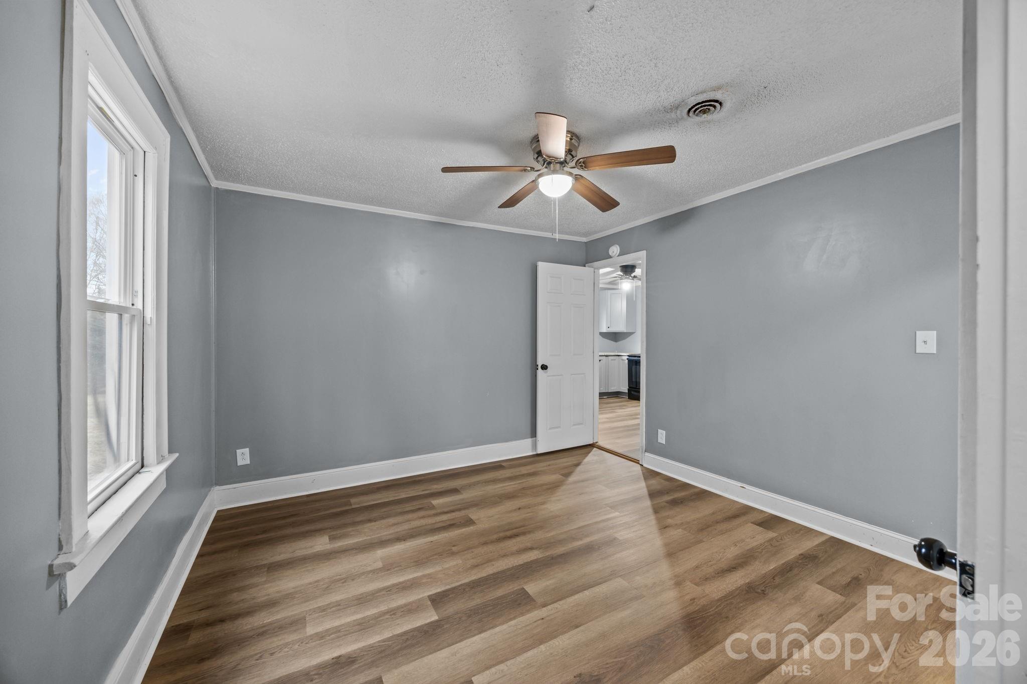 713 2nd St Place Southwest Conover, NC 28613 - Photo 27 of 31 a view of empty room with wooden floor and fan