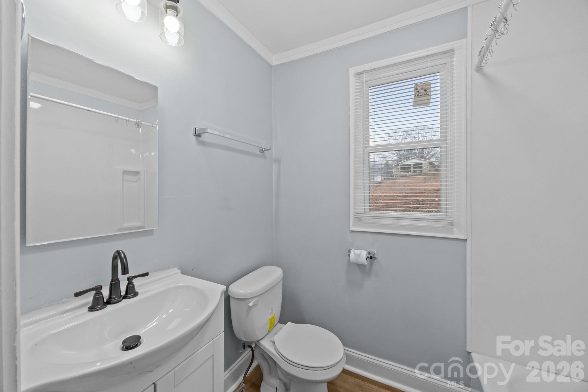 713 2nd St Place Southwest Conover, NC 28613 - Photo 29 of 31 a bathroom with a sink toilet and a mirror