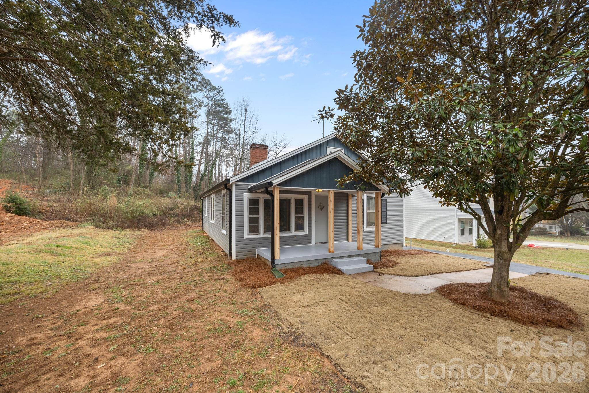 713 2nd St Place Southwest Conover, NC 28613 - Photo 3 of 31 a front view of a house with yard and large tree