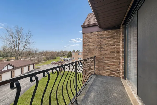a view of balcony with wooden floor and fence