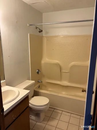 a bathroom with a toilet a sink and shower