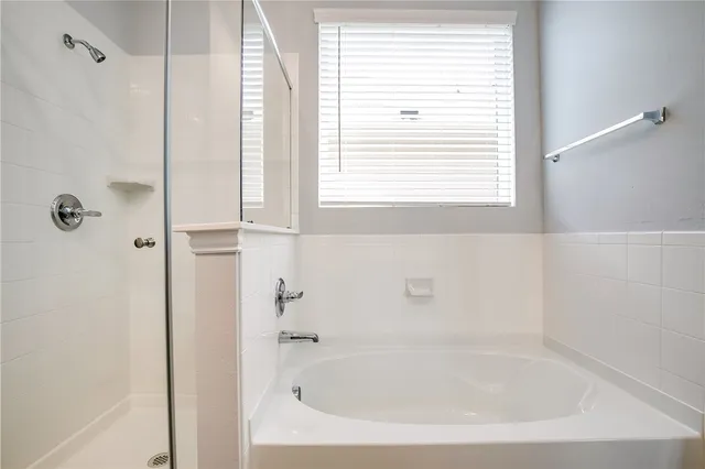 a white bath tub sitting next to a window