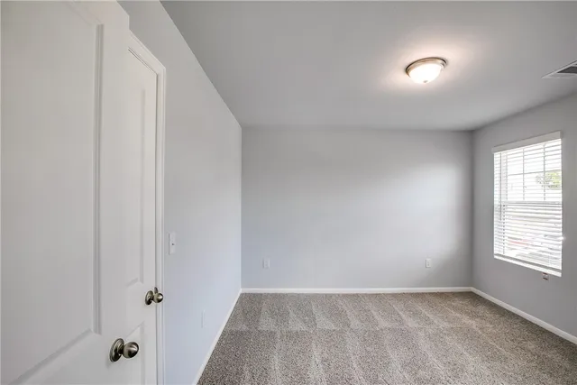 a bathroom with a bathtub shower sink vanity mirror and toilet