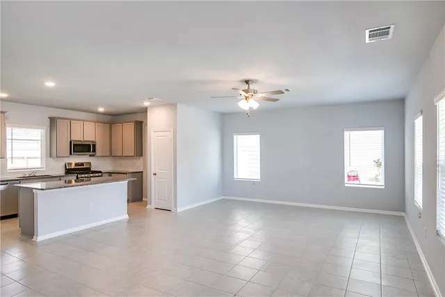 a view of a kitchen with a sink cabinets and wooden floor
