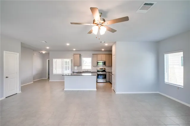 a view of a kitchen with a sink and a window