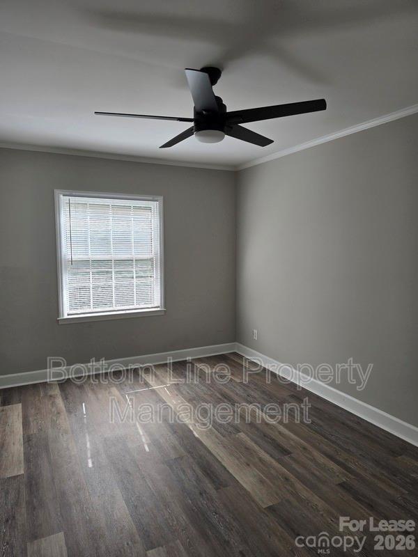 5949 Quail Hollow Road, Unit D Charlotte, NC 28210 - Photo 19 of 34 a view of an empty room with wooden floor and a window