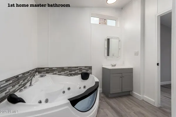 a bathroom with a double vanity sink a toilet and a mirror