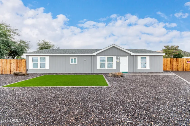 a view of a yard in front of a house with green space