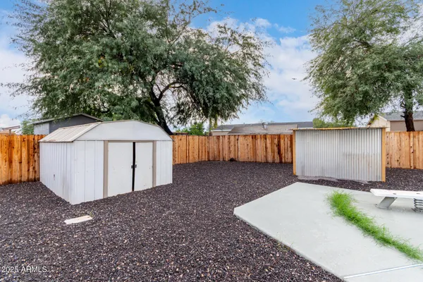 a kitchen with a white cabinets and wooden floor