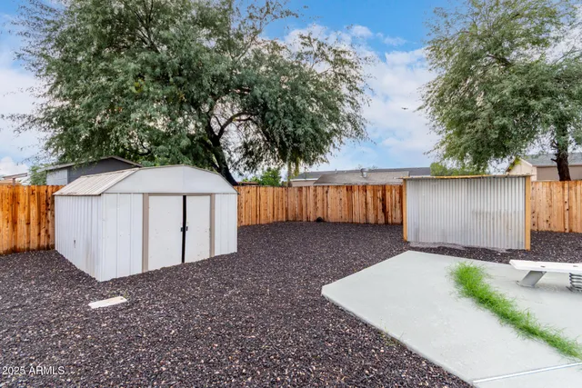 a kitchen with a white cabinets and wooden floor