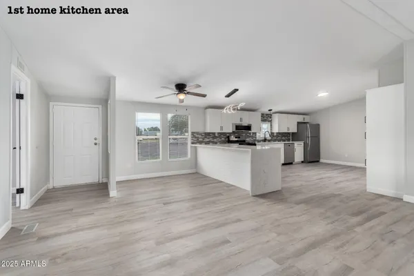 a large kitchen with stainless steel appliances granite countertop a stove and a sink