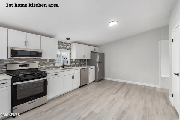 a kitchen with granite countertop a stove top oven and sink