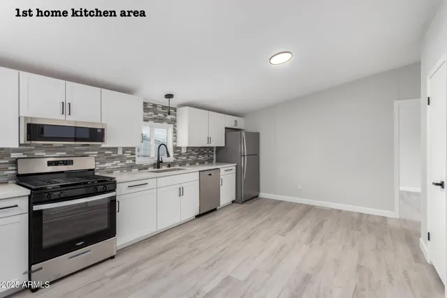 a kitchen with granite countertop a stove top oven and sink