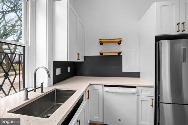 a kitchen with a refrigerator and a sink